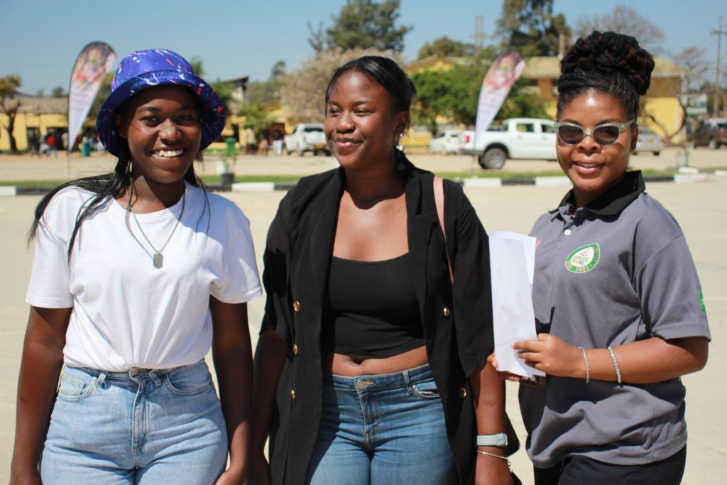 Three Women’s University in Africa students standing together outdoors